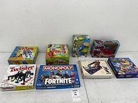 Group shot of all eight boxed games laid out on table