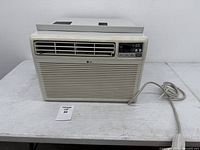 Front view showing LG window air conditioner, front grill, control panel and power cord