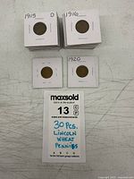 Stacks of 2x2 coin flips labeled 1915-D, 1916, 1920 with note card indicating 30 pcs