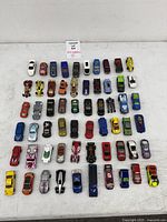 All 60 loose Hot Wheels cars arranged in rows