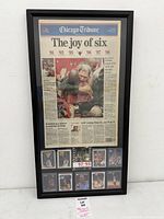 Full view of framed newspaper and cards