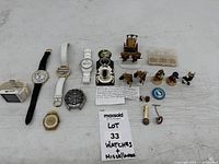 Overall view of six wristwatches, assorted figurines and small collectibles