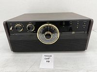 Front view of Victrola console showing control panel, tuner dial, CD drawer and speaker grille