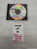 Full view of signed CD in jewel case with lot tag