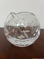 Front and side view of a small clear crystal vase featuring etched leaf and vine decorative pattern.