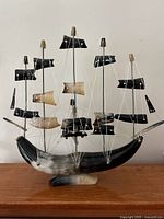 Front view of the vintage nautical decorative ship model with detailed sails and rigging on curved base.