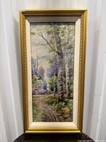 Full view of framed porcelain tile depicting a forest scene with a dirt path and birch trees in springtime.
