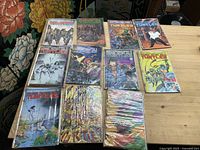Overview of 11 bagged Teenage Mutant Ninja Turtles comic books on wooden table