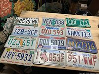 All twelve license plates laid out in four rows