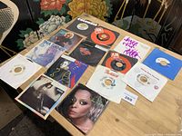 Overview of all fourteen 7" singles laid out on table