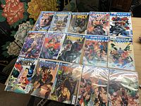 All 15 bagged comic books laid out, titles visible