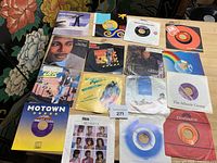 All seventeen 7" singles laid out to show fronts of sleeves and labels