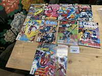 All nine comic books laid out on table