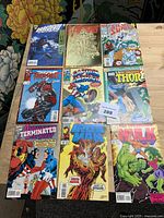 Overhead view of all nine comics laid out in three-by-three grid