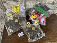 Group of packaged Create A Bear outfits on table