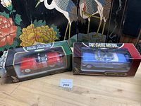 Both boxed diecast cars side by side