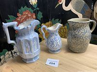 All three pitchers side by side on table