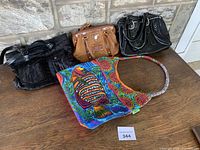 All four handbags on table