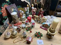 Full tabletop view of assorted ornaments, candles and figures