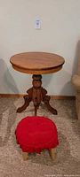 Full view of the vintage wooden occasional table showing round tabletop and pedestal base