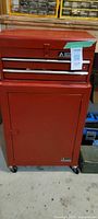 Photo of the red Alltrade tool cart with closed drawers and cabinet, showing overall condition and size.