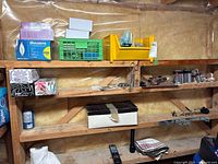 Wide shot of shelves containing multiple items, including the boxed Bulbrite chandelier bulbs seen on the middle shelf left side.