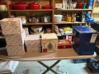 Overview of multiple Spode Christmas Tree boxed pieces including small boxes, pedestal bowl box, butter dish box and large blue box