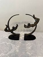 Pair of bronze acrobat bookends showing sculptural details and overall size