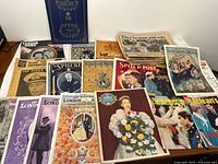 Overview photo of assorted vintage and modern magazines and newspapers centered on British Royal Family historical events.