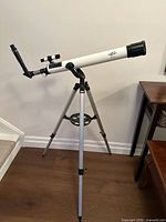 Full view of Orbiter 2010 telescope mounted on tripod showing overall length and stability.