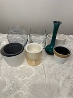 Photo shows seven items including clear round and square glass vases, a tall vintage green vase, and various pots including the Lee Valley hydroponic pot with a transparent outer shell and several smaller pots.