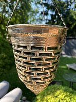 Front and side views of vintage lantern showing metal brick pattern and green glass panels with hanging chain.