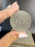 Reverse view showing floral design with Canadian provinces and inscriptions.