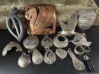 Group shot of 13 jewelry pieces on black surface