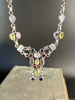 Front view of pendant cluster showing multicolor gemstones