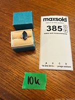 Ring in blue box next to auction card and 10K label