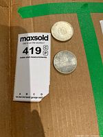 Two silver coins on cardboard, one with emblem visible, the other showing text and date 1966