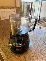 Black Cuisinart Prep 11 Plus food processor with clear plastic bowl on kitchen countertop