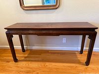 Full front view of console table showing rectangular top, apron and bracket feet