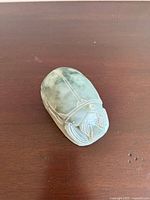 Top view of the green marble soapstone scarab beetle paperweight showing detailed carving and polished finish.