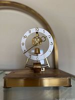 Front view of the vintage Kundo electronic mantle clock showing the full dial and mechanism.