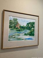 Framed watercolor painting hanging on wall showing the full artwork and frame.