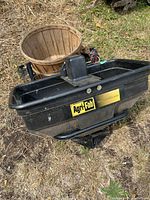 Top view of Agri-Fab spreader showing hopper, logo, wiring harness