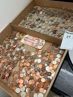 Tray showing assorted Canadian coins and $2 bill