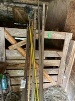 Overall view of grouped poles leaning in barn stall