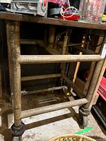 Full view of metal table frame and casters