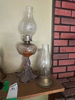 Both kerosene lamps side by side showing size and design differences