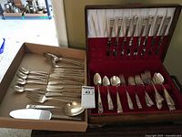 Overall view of flatware in chest and additional pieces in box
