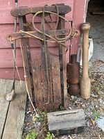 Front view of sled, toolbox, three exercise clubs, golf club