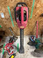 Full view of red Toro handheld leaf blower with long black tube